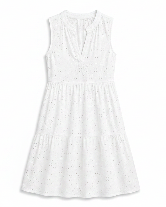 A sleeveless white eyelet dress with a tiered skirt and split neckline, shown flat against a solid beige background.