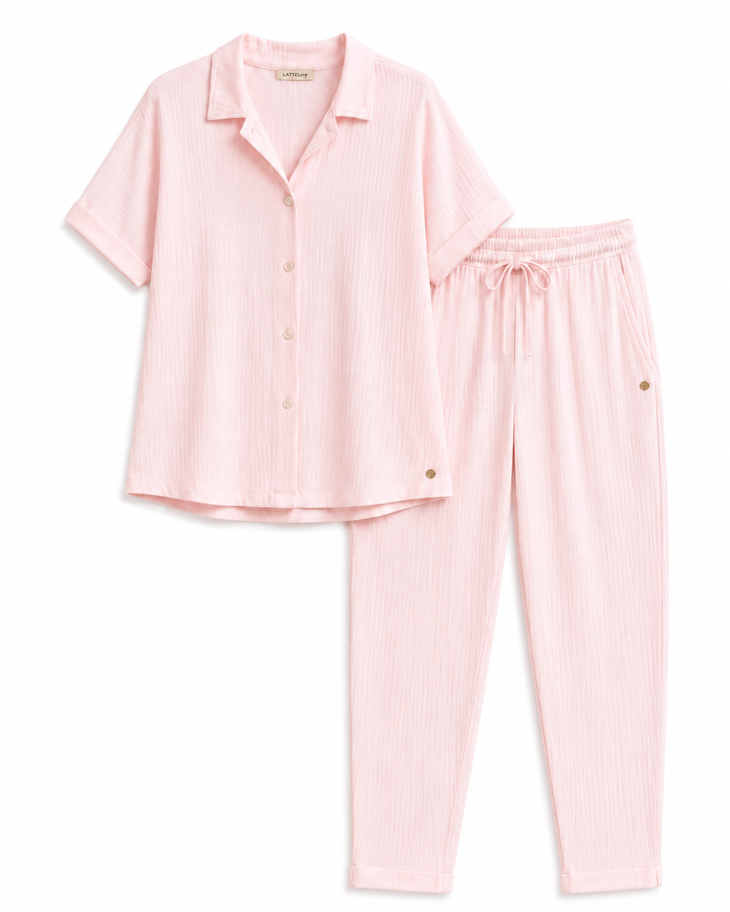 A light pink two-piece pajama set consisting of a short-sleeve button-up shirt and matching drawstring pants, laid flat on a white background.