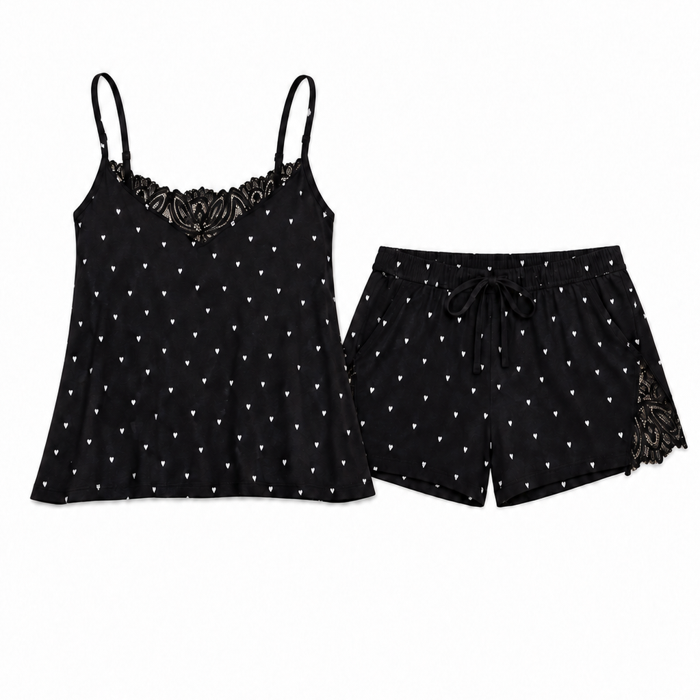 A two-piece women's pajama set featuring a black camisole top with thin straps, a lace-trimmed neckline, and white polka dots, paired with matching black shorts that have a drawstring waist and lace trim at the side hem, shown on a plain white background.