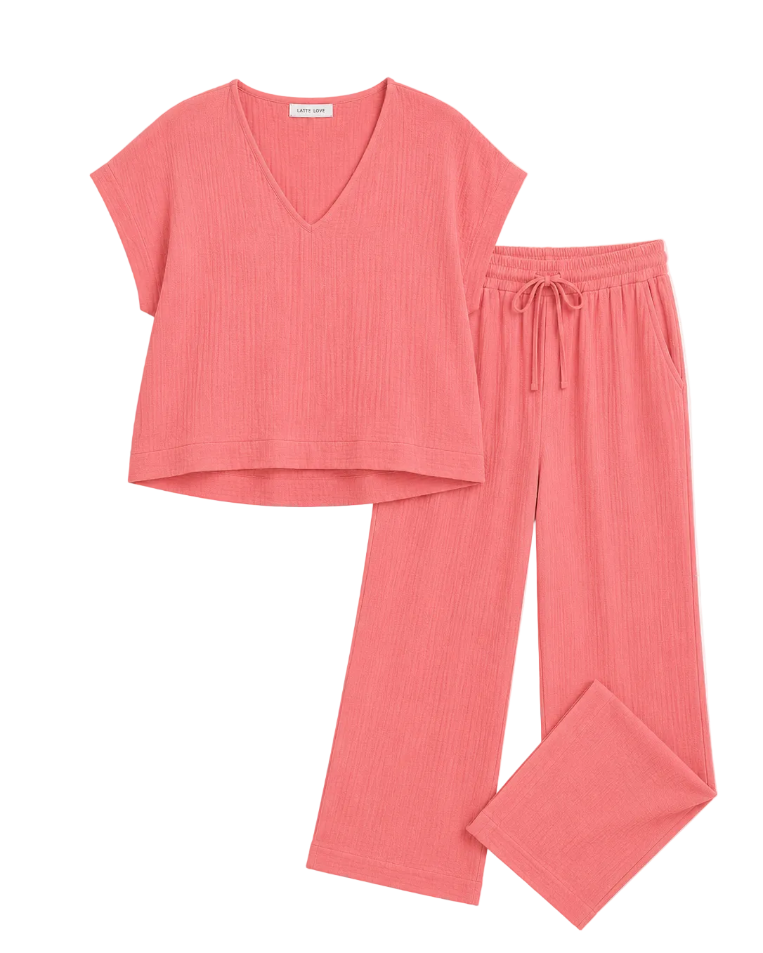 A two-piece loungewear set in a ribbed coral pink fabric, featuring a short-sleeve V-neck top and matching drawstring pants, laid flat on a light off-white background.