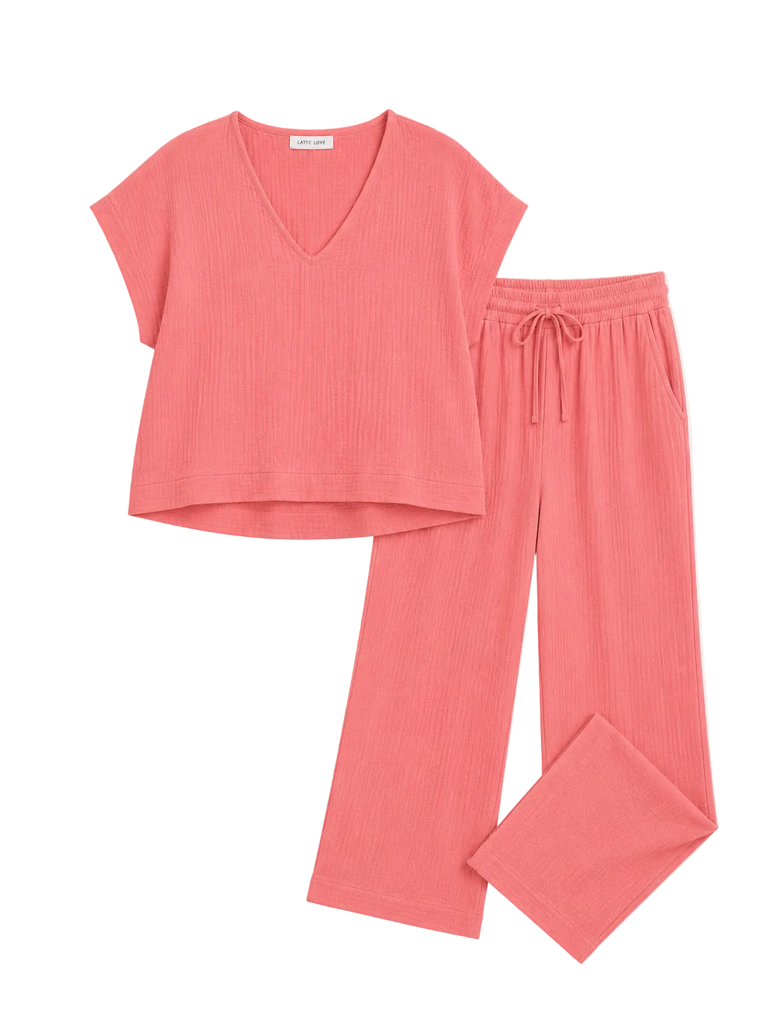 A two-piece loungewear set in a ribbed coral pink fabric, featuring a short-sleeve V-neck top and matching drawstring pants, laid flat on a light off-white background.