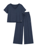 A two-piece navy blue loungewear set consisting of a short-sleeve V-neck crop top and matching wide-leg drawstring pants, laid flat on a light beige background.
